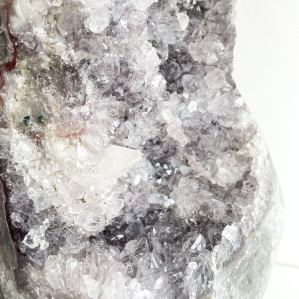 Close-up of a geode with amethyst crystals and white quartz.